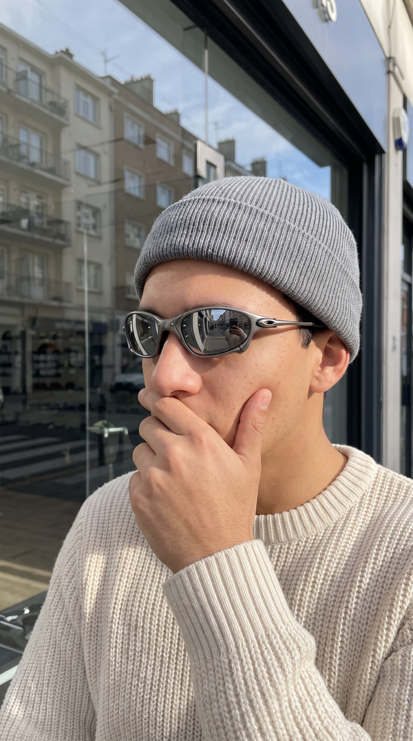 Person wearing ALLOY metal sunglasses with silver mirror lenses on a city street