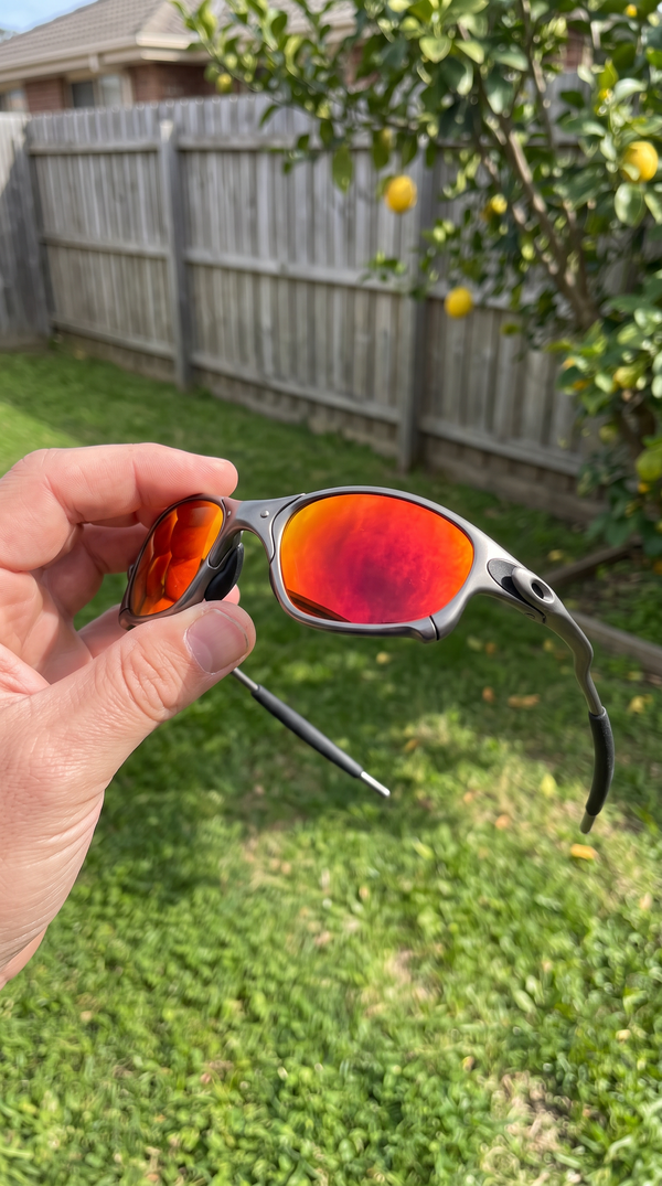 ALLOY metal sunglasses with red mirror lenses in a backyard